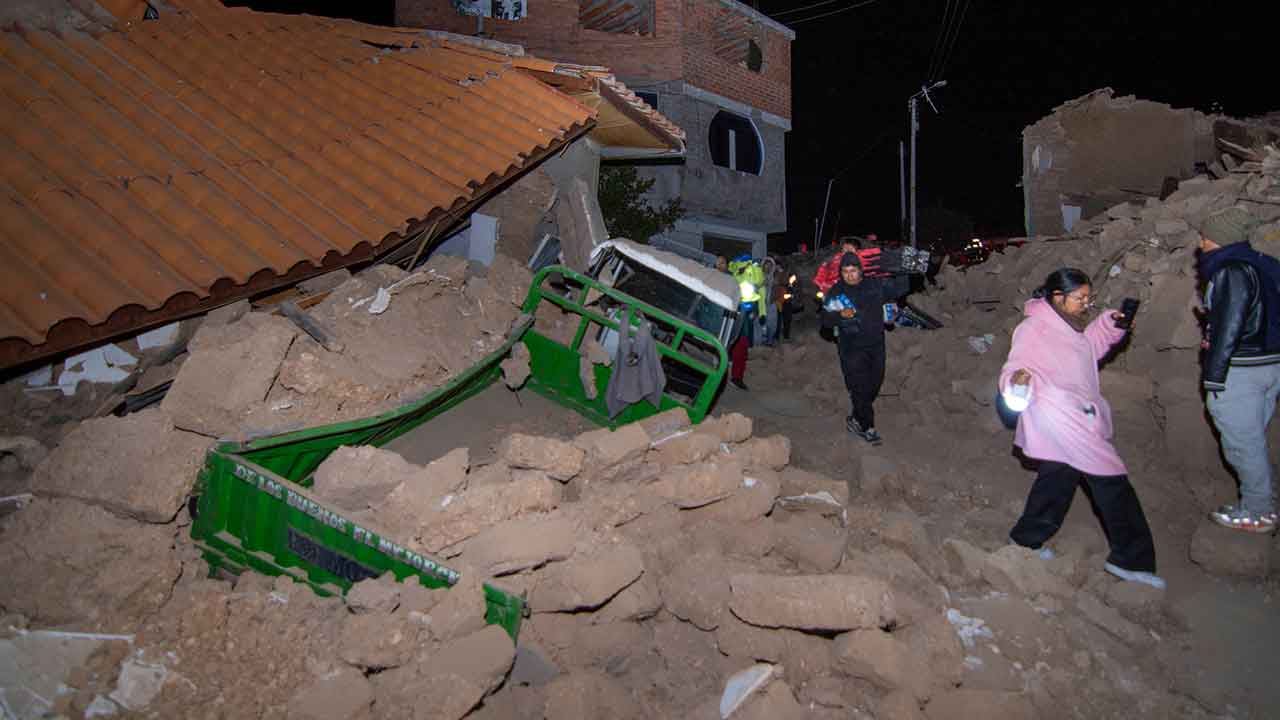 Residents walk amid the debris of homes that collapsed after an earthquake struck Pumpuya, Peru, Sunday, July 19, 2026. ( AP Photo/Javier Ninanya)