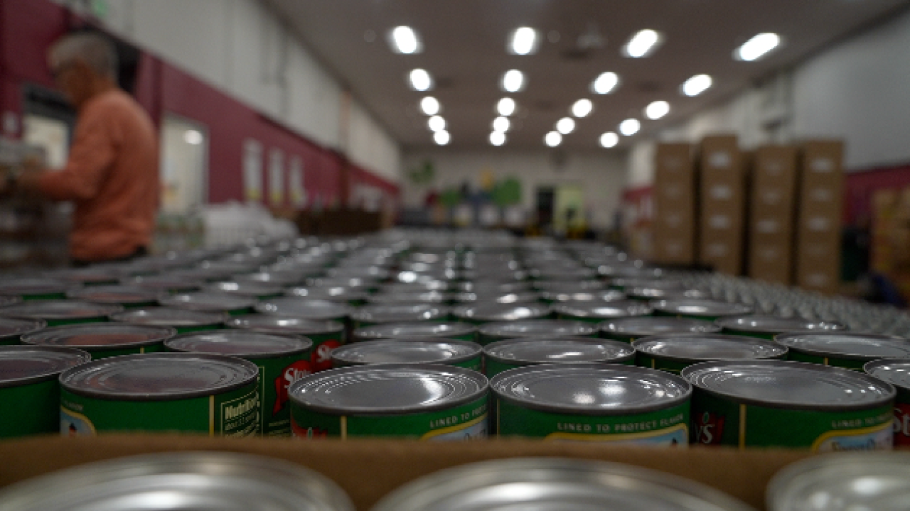 Volunteers pack food at a Food Bank of the Rockies distribution center.