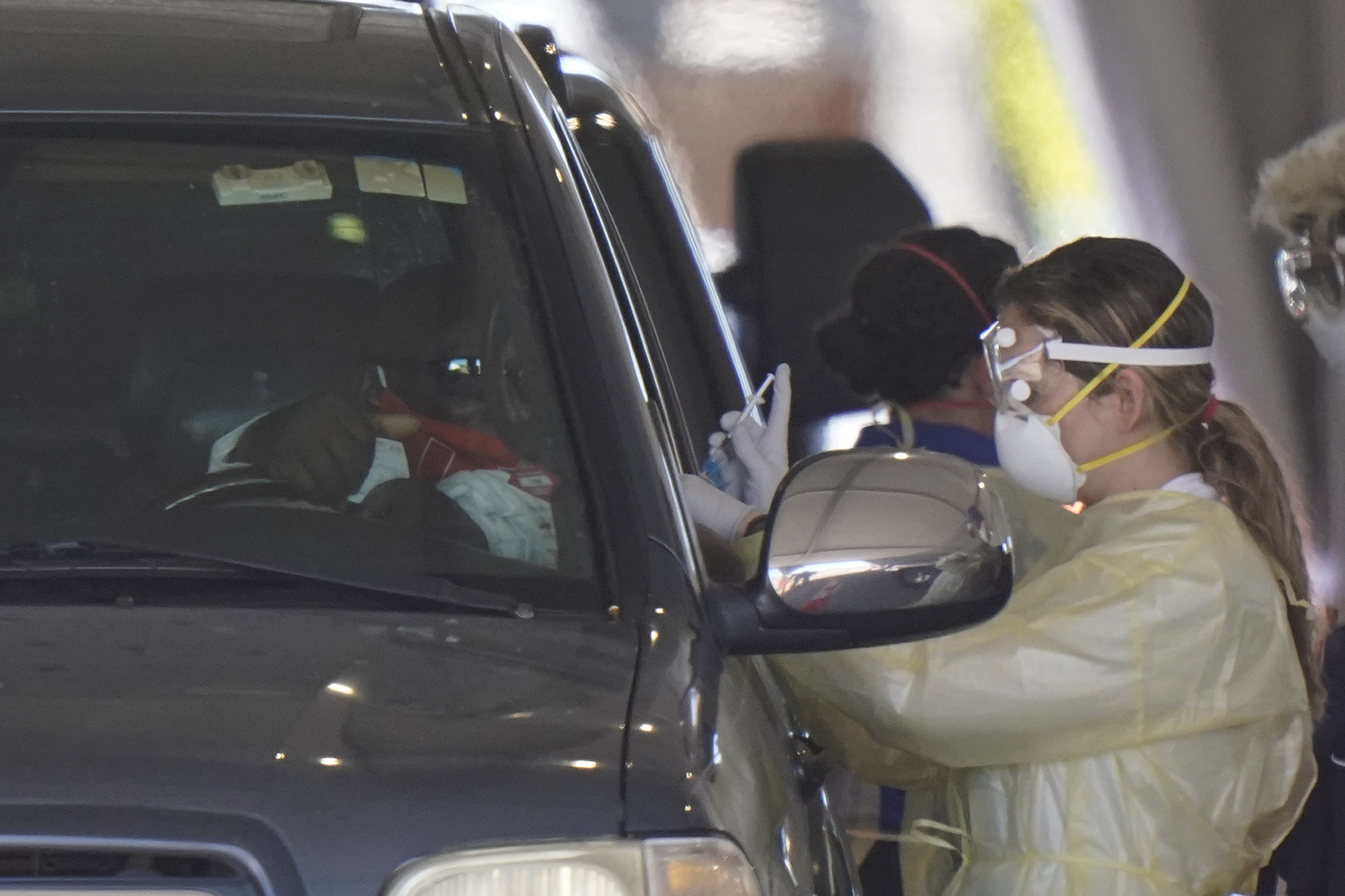 Driver gets COVID-19 vaccine at Hard Rock Stadium, Jan. 6, 2021