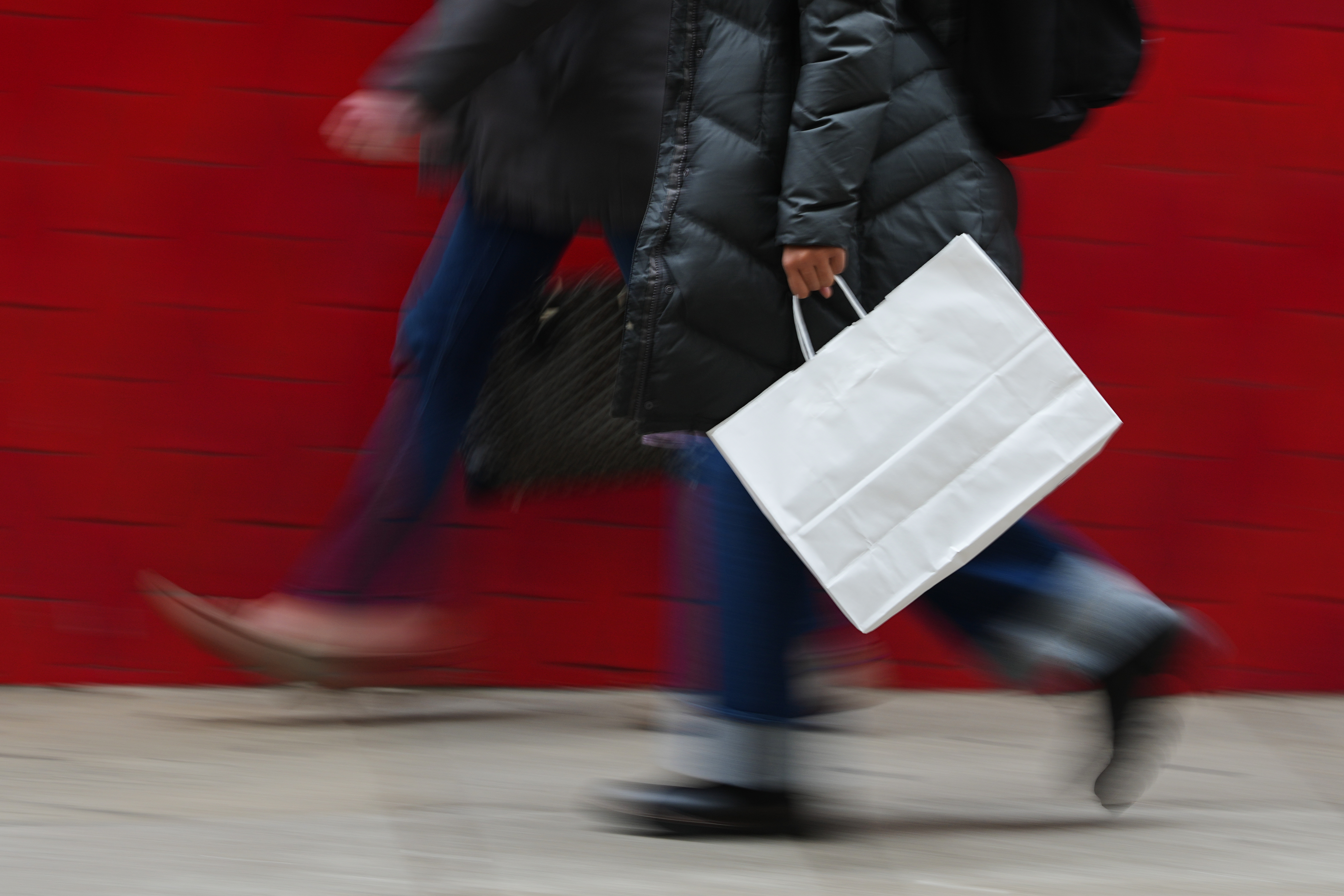 FILE - A person carries a shopping bag in Philadelphia, Dec. 10, 2025.