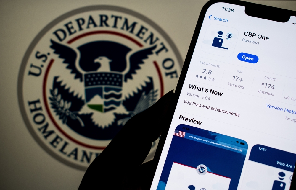 The CBP One app is displayed on a smartphone in from the the U.S. Department of Homeland Security seal.
