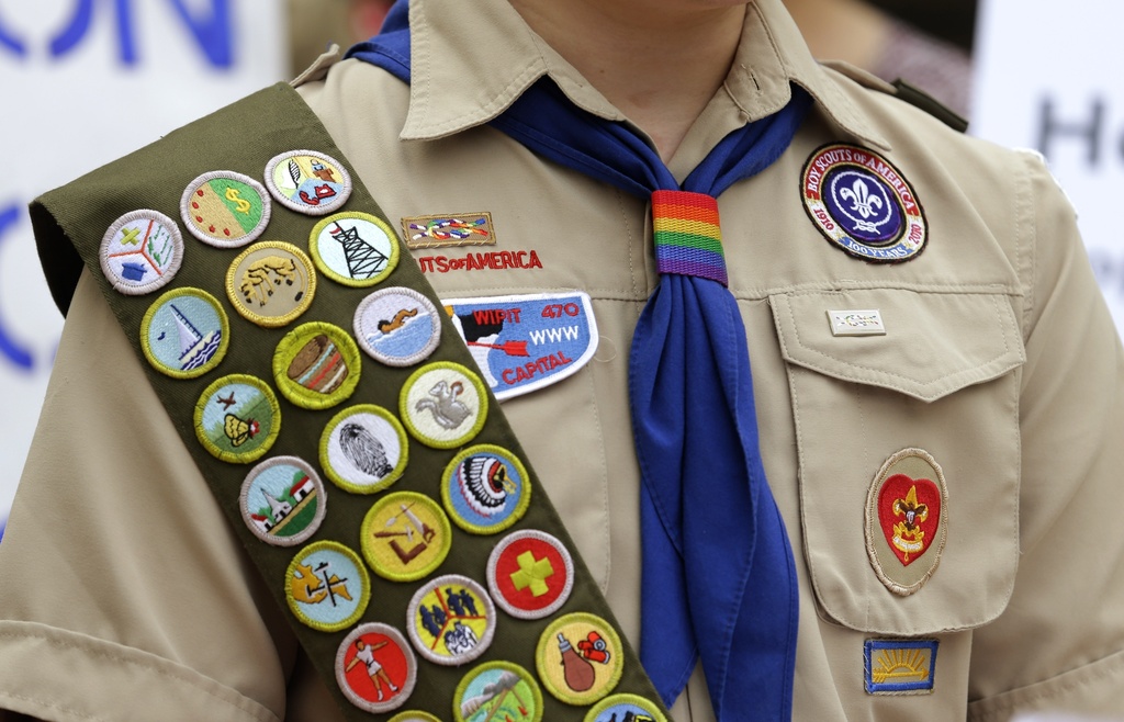 Merit badges and a rainbow-colored neckerchief slider are affixed on a Boy Scout uniform outside the headquarters of Amazon in Seattle. 