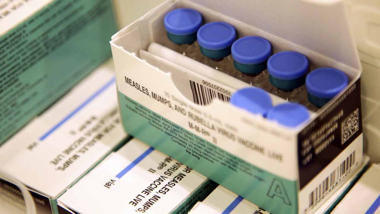 Vials of measles, mumps and rubella vaccine sit in a cooler.