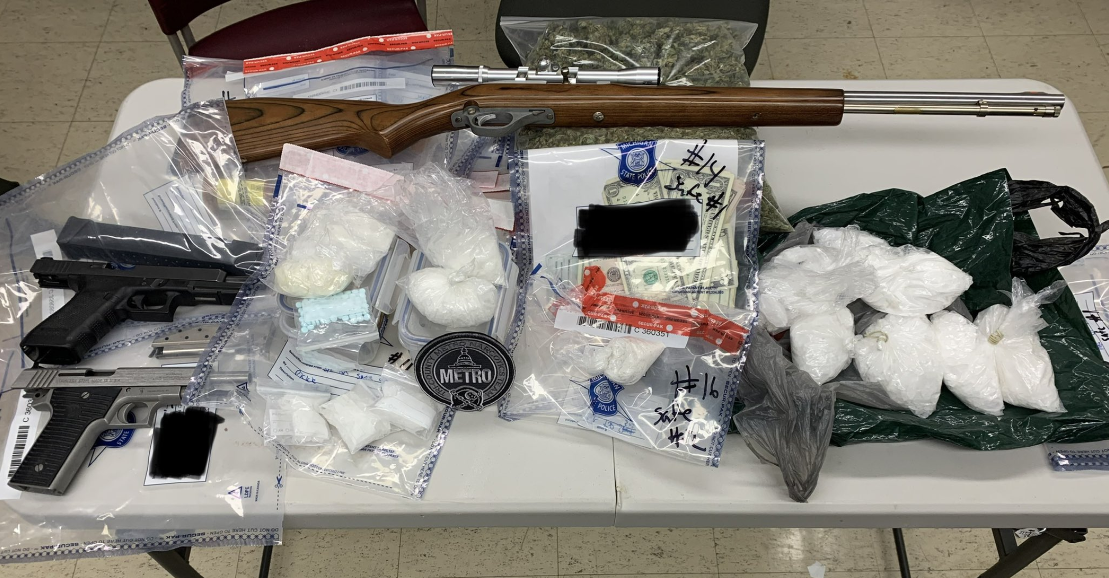 Several pounds of drugs, cash and guns seized from Lansing home