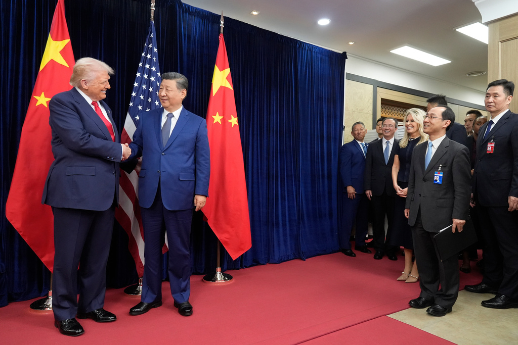 President Donald Trump, left, and Chinese President Xi Jinping shake hands before their meeting at Gimhae International Airport in Busan, South Korea, Thursday, Oct. 30, 2025.