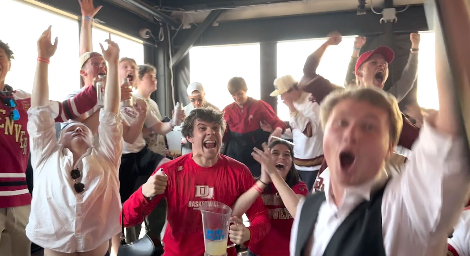DU Hockey fans celebrate a tying goal that would send their Frozen Four game against Western Michigan into overtime.
