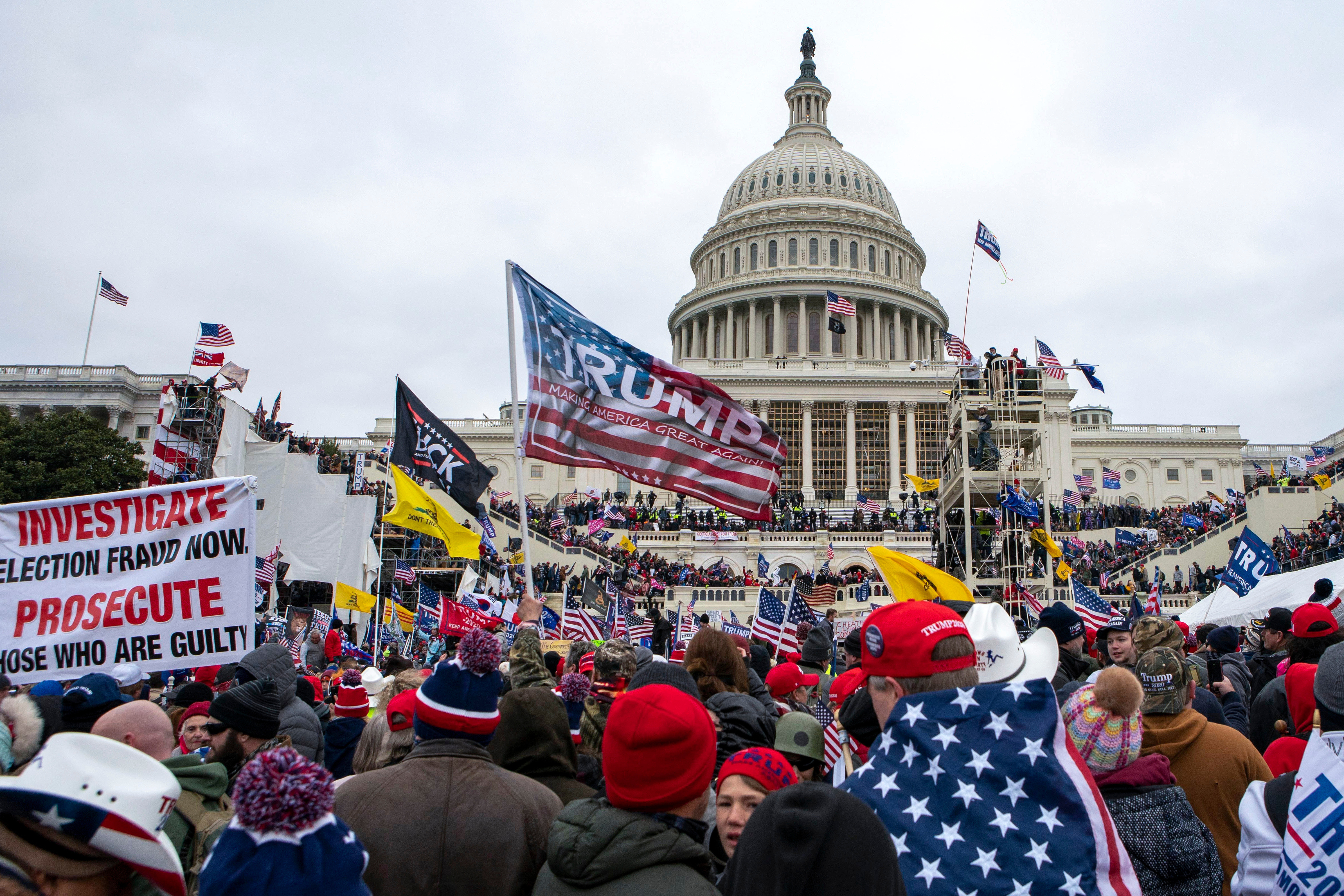 FILE - Rioters loyal to President Donald Trump rally at the U.S. Capitol in Washington, Jan. 6, 2021. 