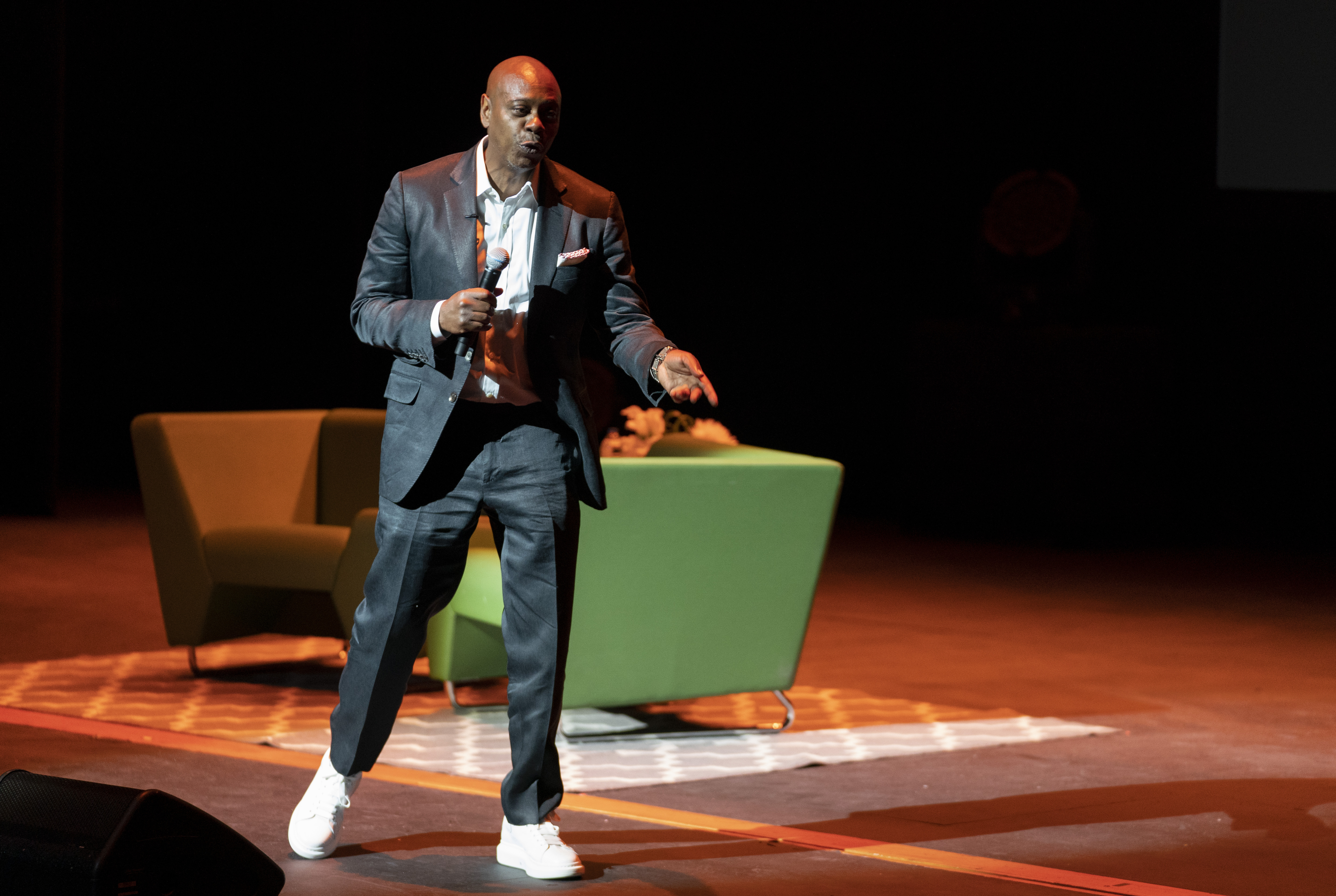 Dave Chappelle motions during performance to raise funds to support Duke Ellington School of the Arts in Washington, June 20, 2022