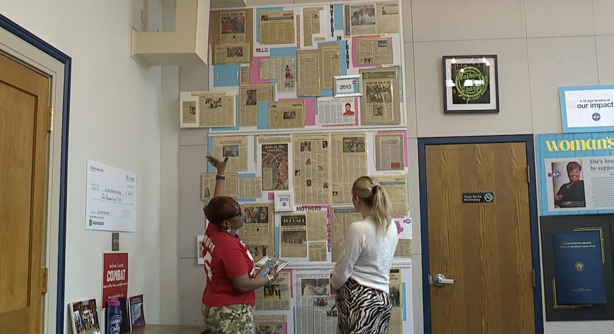 Rosilyn Temple explains the wall at her office filled with news clippings about the work of KC Mother's in Charge