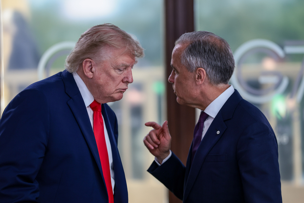 FILE - President Donald Trump speaks with Canadian Prime Minister Mark Carney, right, at a working lunch with leaders of G7 and the Middle East in Evian-les-Bains, France, Tuesday, June 16, 2026.