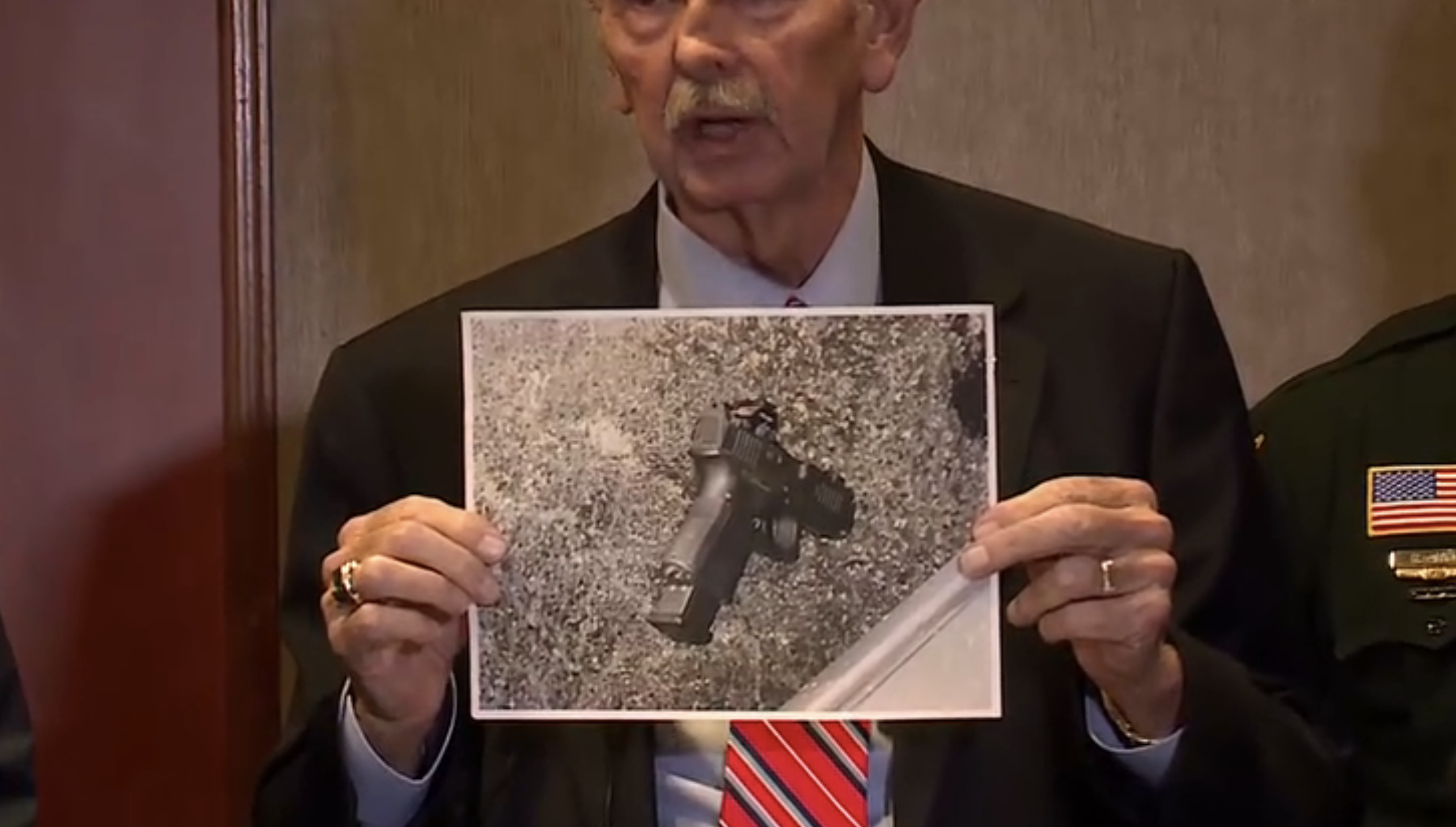 Sheriff Ric Bradshaw holds up image of gun the 30 year old man had in his hand during news conference.png
