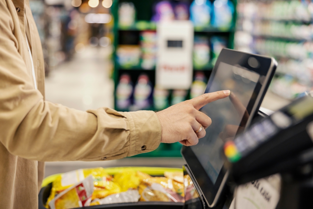Man using a self-checkout machine.