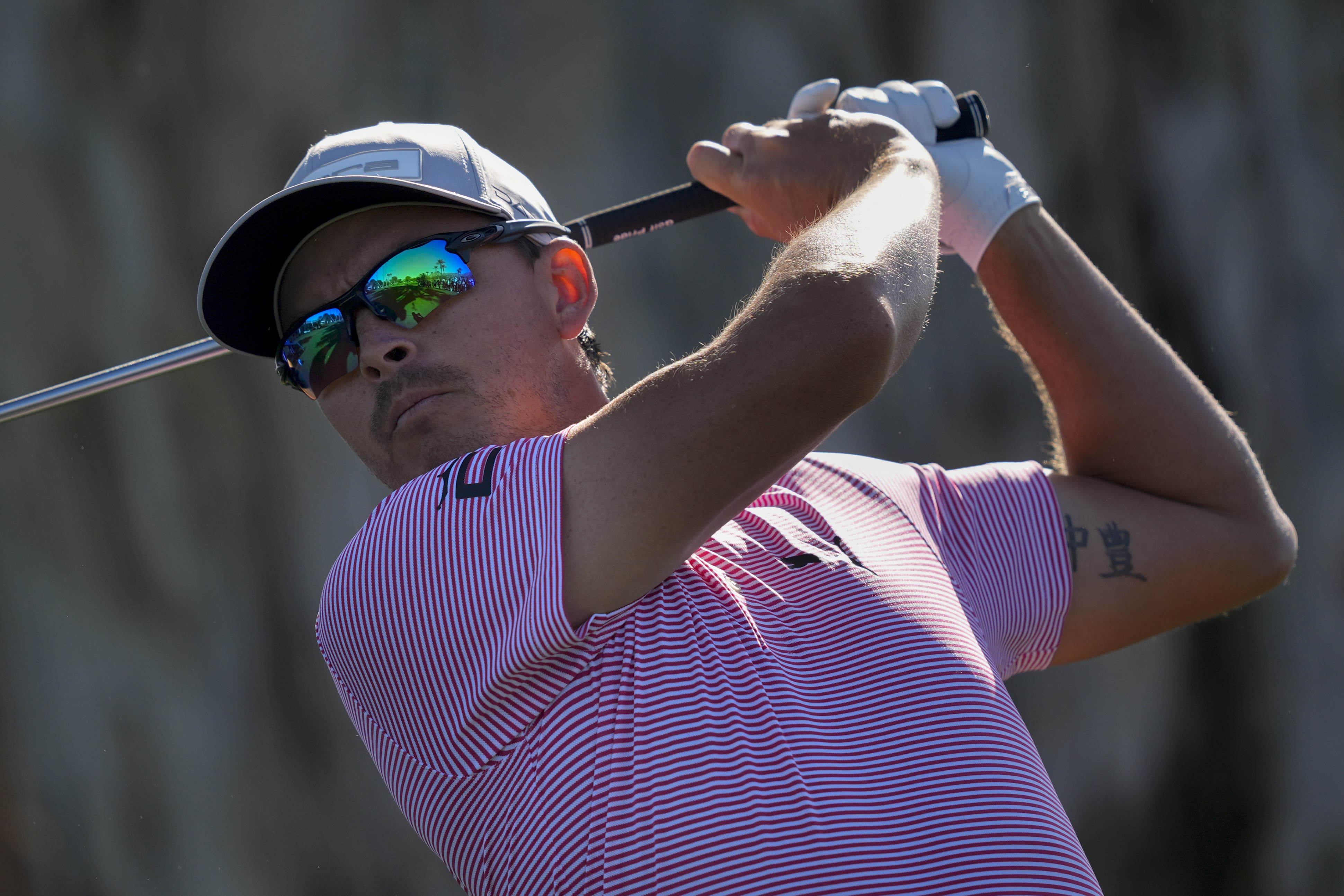 Rickie Fowler watches tee shot on fourth hole in first round of 2024 American Express tournament