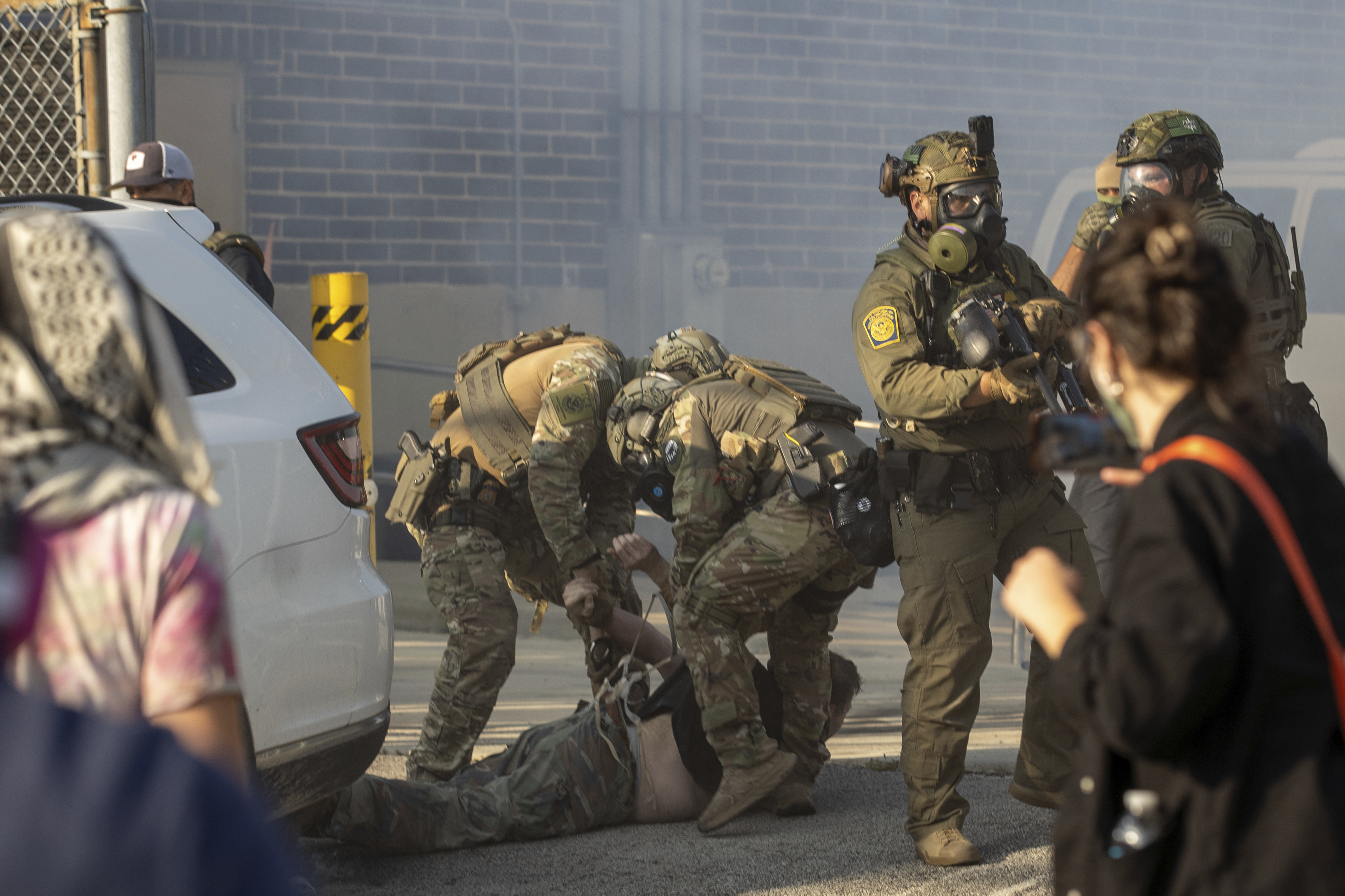 Immigration and Customs Enforcement officers arrest a protester at the ICE facility in Broadview, Ill., Friday, Sept. 19, 2025. 