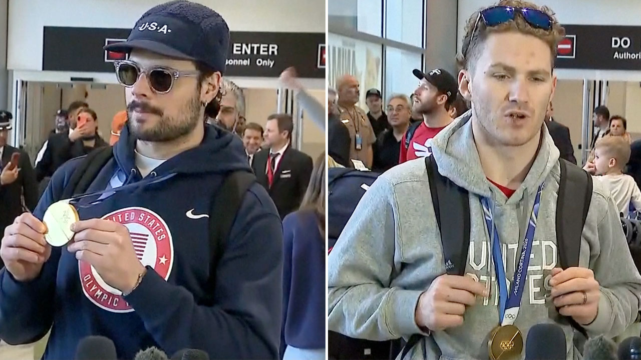 Team USA center Auston Matthews and forward Matthew Tkachuk show off their gold medals after landing at Miami International Airport on Feb. 23, 2026.