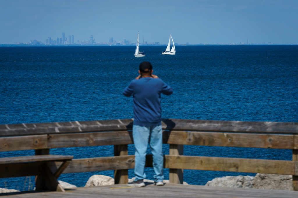 A person photographs boats on Lake Ontario from Fifty Point Conservation Area in Grimsby, Ontario, Canada, on Saturday, Aug. 29, 2026