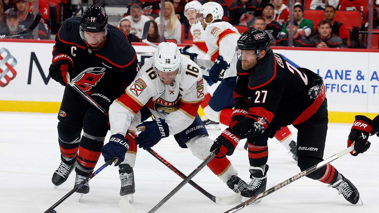 Florida Panthers' Aleksander Barkov (16) battles for the puck between Carolina Hurricanes' Jordan Staal, left, and Nikolaj Ehlers (27) during the third period of an NHL hockey game in Raleigh, N.C., Tuesday, Sept. 29, 2026.