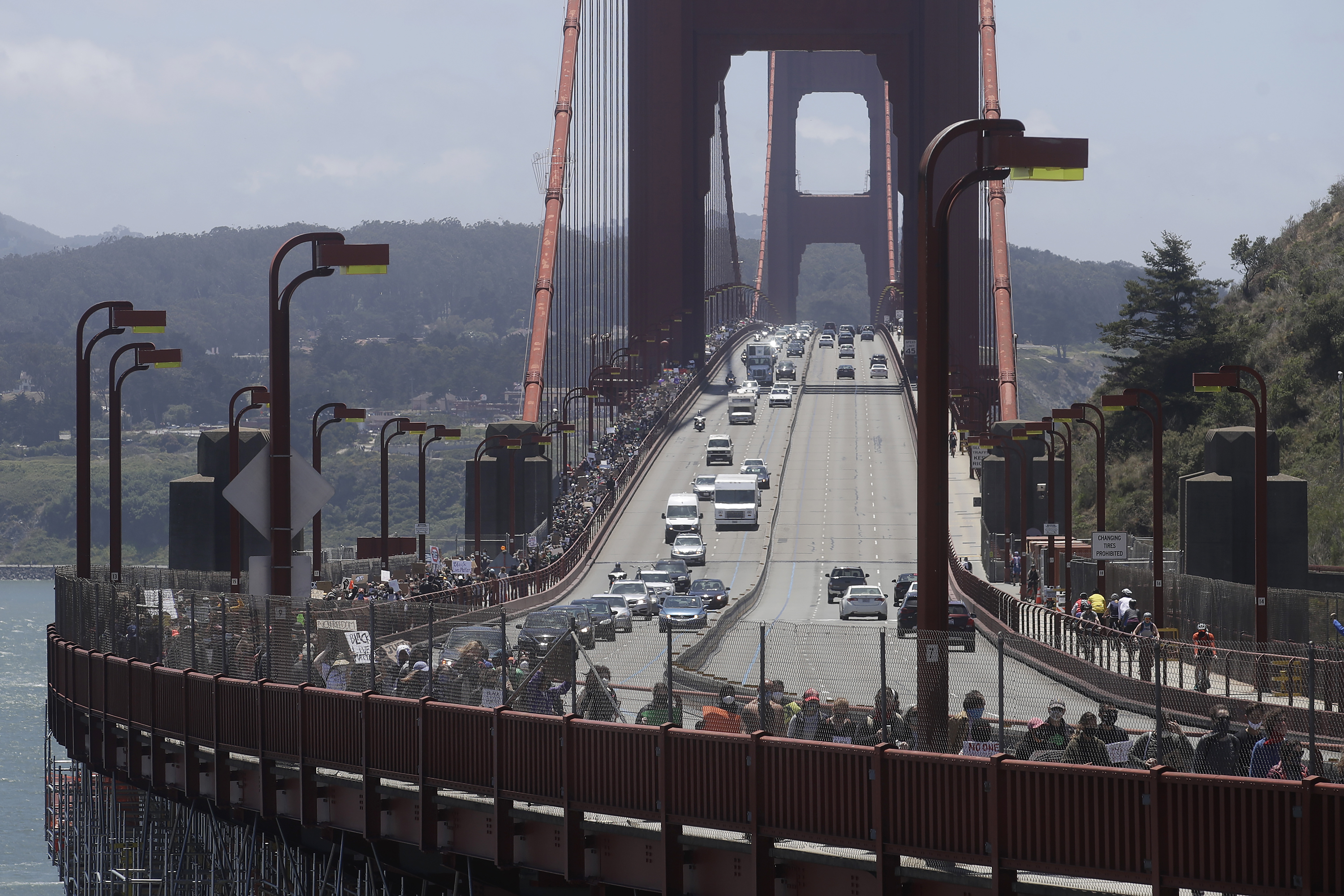 Couple engaged on Golden Gate Bridge during Black Lives Matter protest