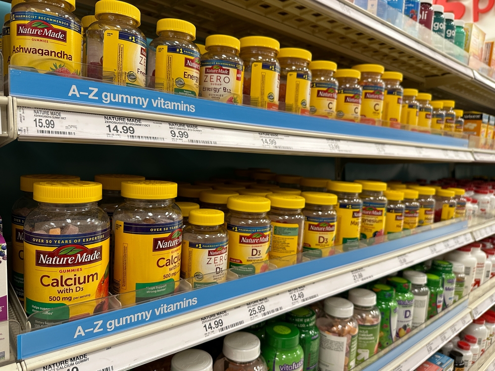 Stock image of vitamins and supplements on store shelves.