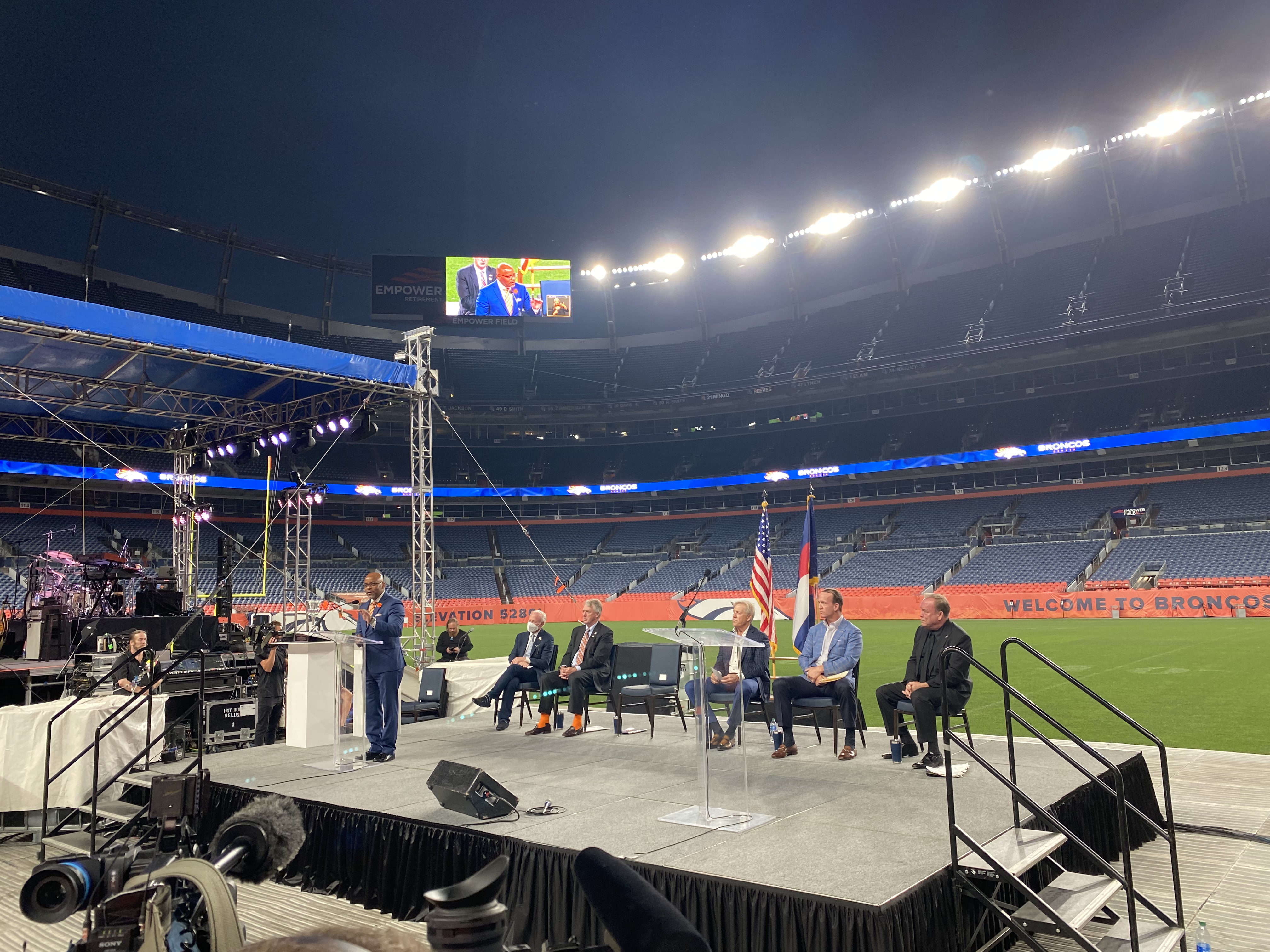 Dignitaries at Empower Field for the Community Enrichment Award being given to Joe Ellis