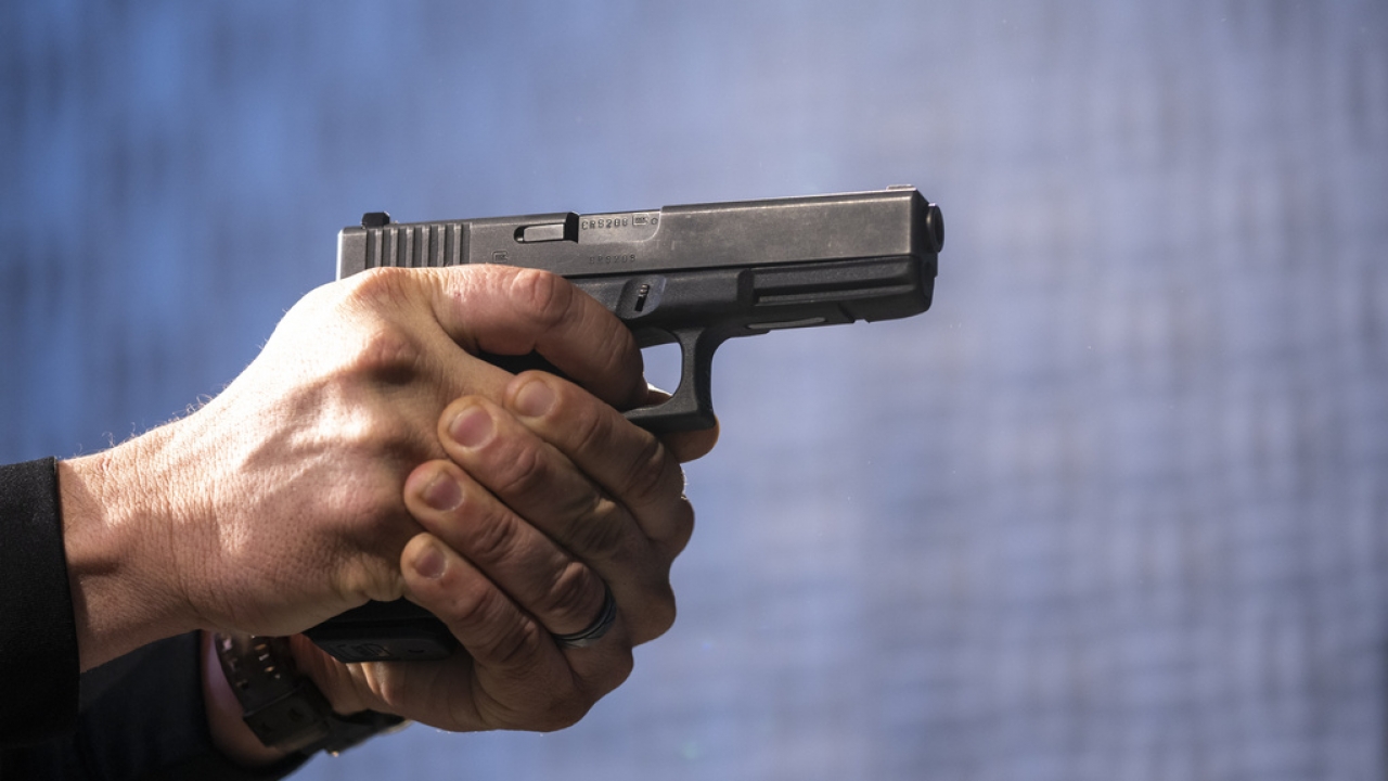 A semi-automatic Glock pistol is shown.