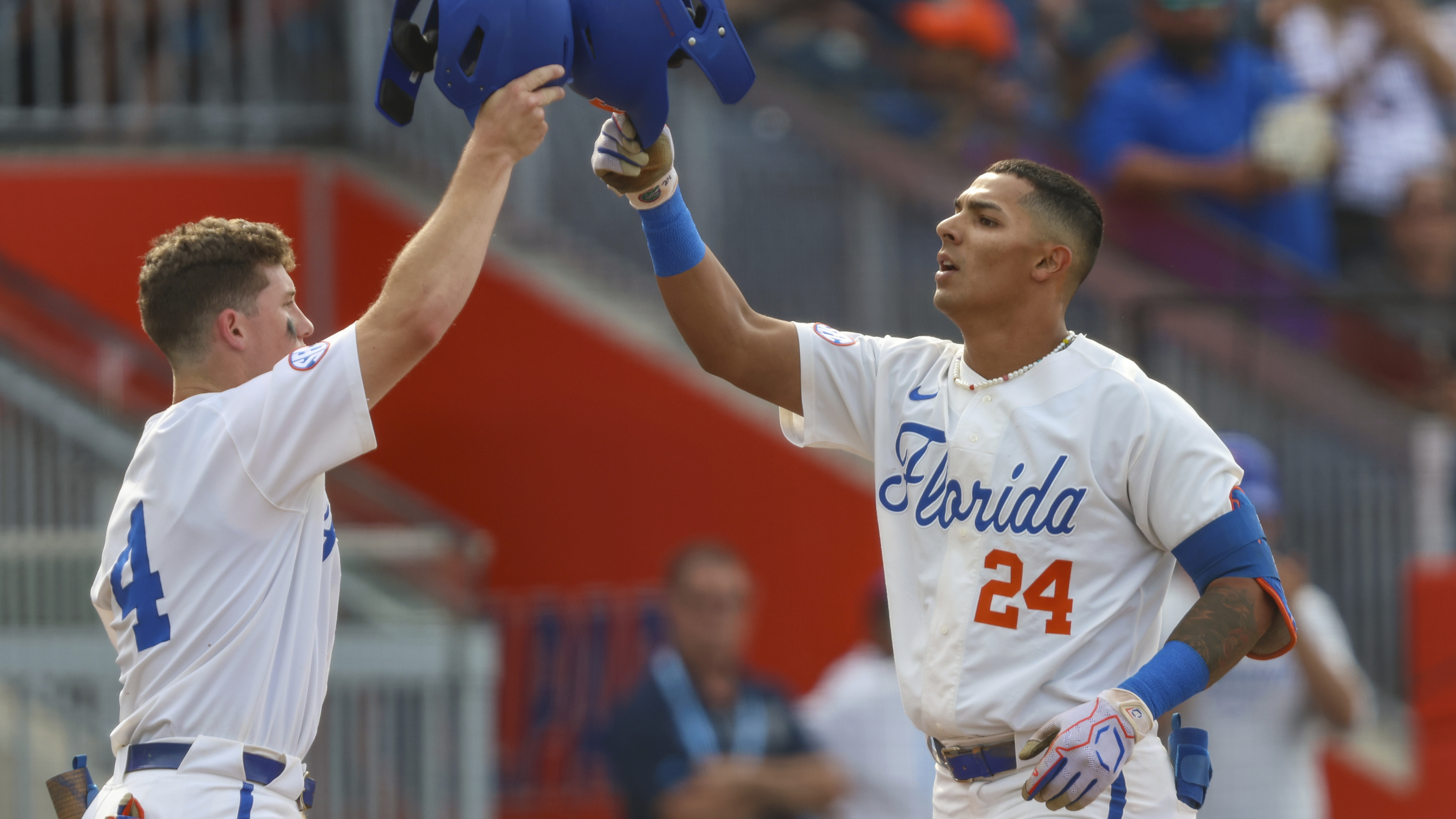 Florida Gators shortstop Josh Rivera celebrates 2-run home run with teammate Cade Kurland, June 2, 2023