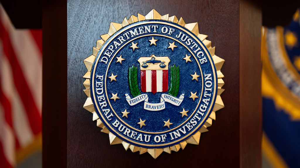 FILE - An FBI seal is displayed on a podium before a news conference at the field office in Portland, Ore., Jan. 16, 2025.