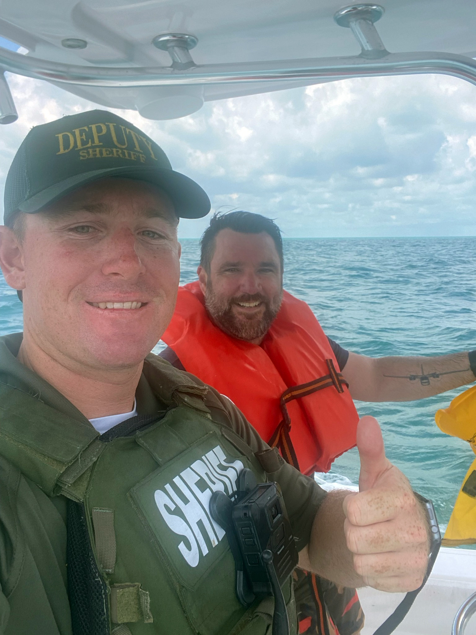 Monroe County Sheriff's Office Deputy Trevor Pike takes Adam Joseph Barney in a boat to paramedics after his small plane crashed 13 miles off the Lower Keys on Sunday. Aug. 13, 2013.
