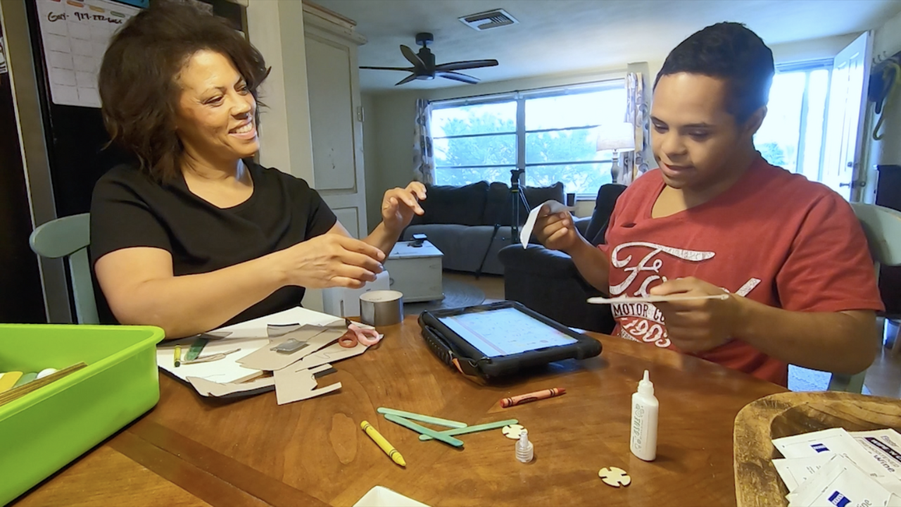 Gretchen Stewart and her son Ian Stewart at the kitchen table 
