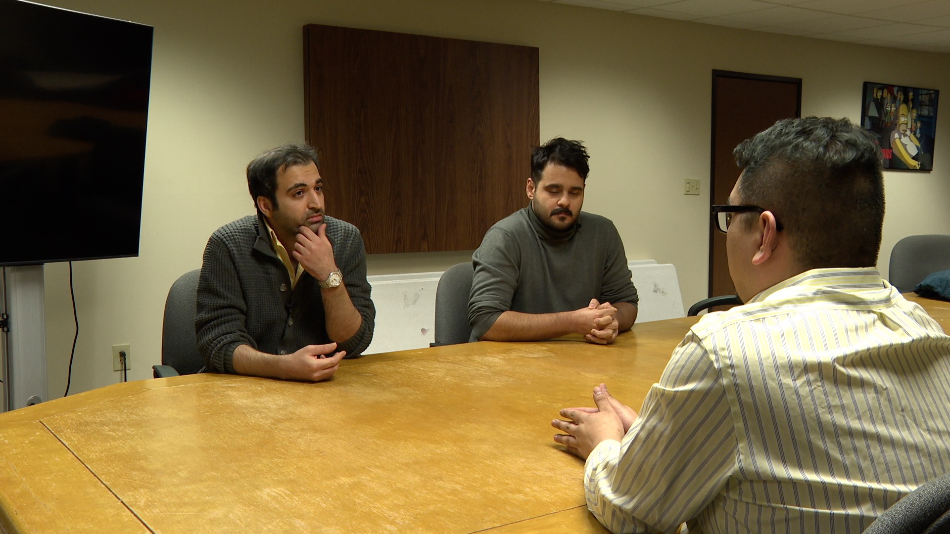 Danny Valle speaks with two neighbors who hail from Iran