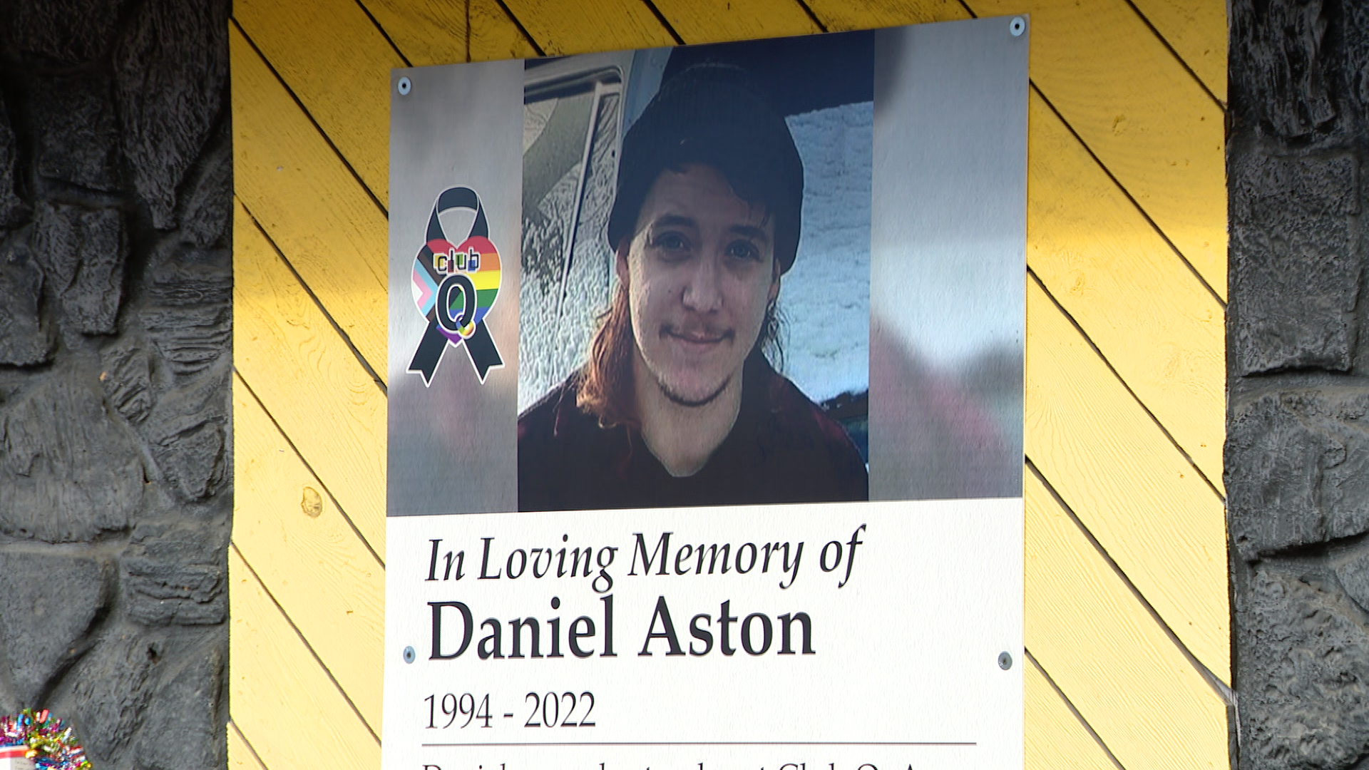 Daniel Aston's banner lines the side of Club Q, along with the other victims who lost their lives.