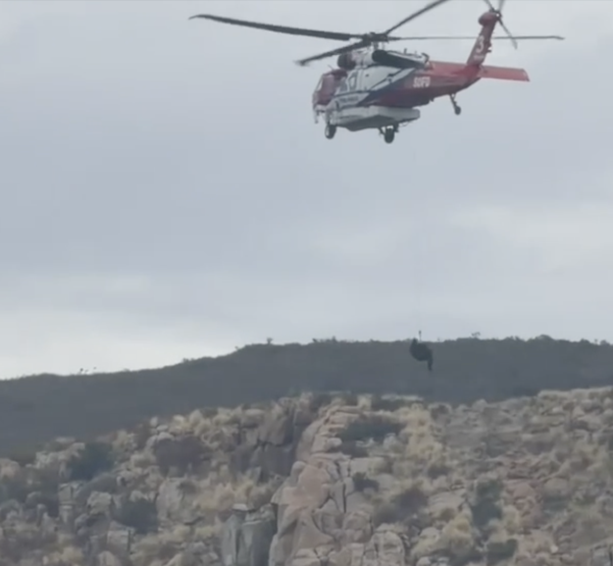 Flight medic dangles from helicopter rope in dramatic rescue
