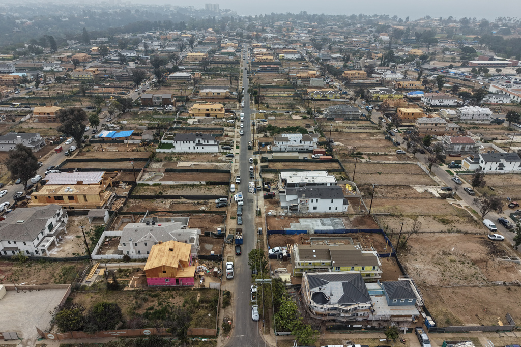  An aerial view shows homes under construction amid empty lots more than a year after the Palisades Fire in the Pacific Palisades neighborhood of Los Angeles, Thursday, June 4, 2026. 