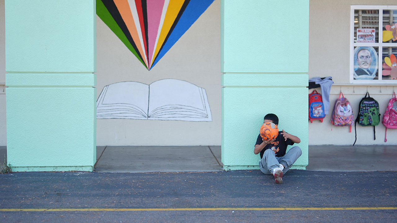 A student takes a break from soccer during recess at Perkins K-8 School Thursday, Nov. 13, 2025, in San Diego. (AP Photo/Gregory Bull)