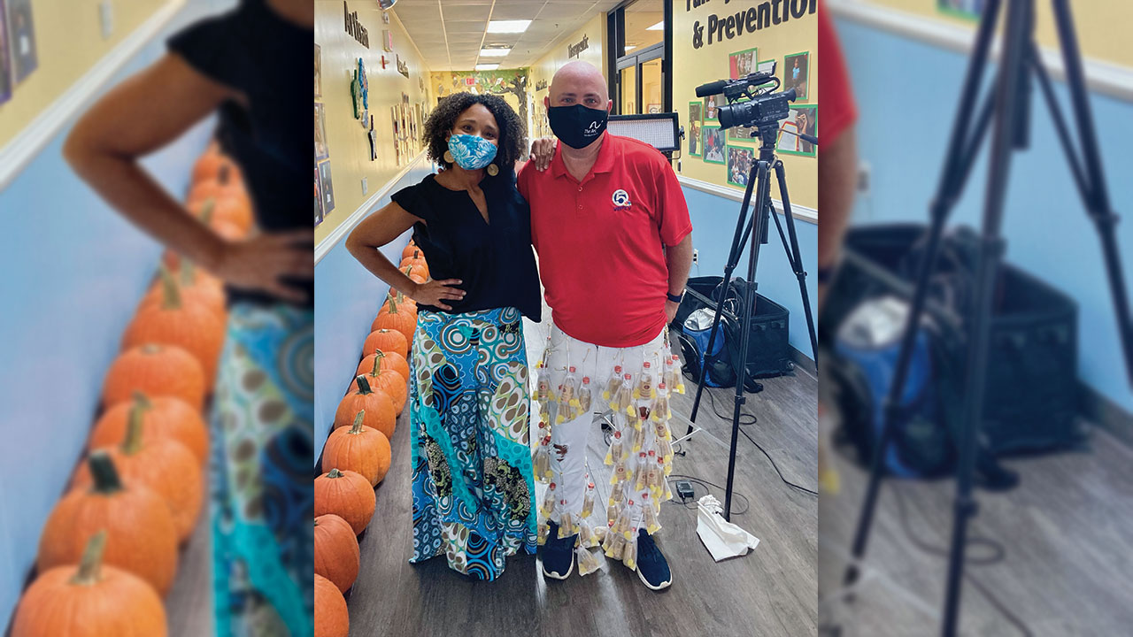 Arc of Palm Beach County spokesperson Shelli Lockhard poses with Entertainment Reporter T.A. Walker in their Wild Pants.  Walker's pants feature 60 bottles of Tito's Handmade Vodka (which were donated by the Austin, TX-based company).  The Wild Pants Party is a fundraising event that has gone virtual this year because of the coronavirus pandemic.