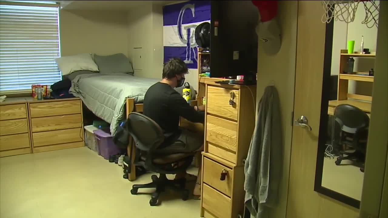 student in dorm with mask