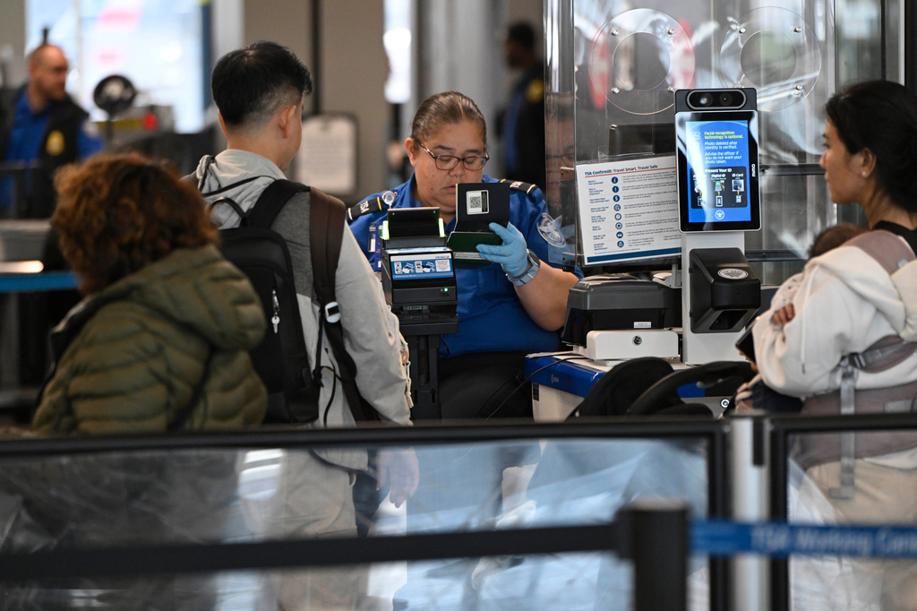 Passengers are screened by a TSA agent at O'Hare Airport in Chicago, Thursday, March 26, 2026. 