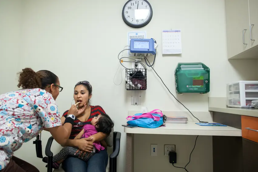 Medical assistant Alesia Bolden checks Nereyda Penaloza's vital signs during a visit to Women's Services at CommUnityCare, a federally qualified health center, Feb. 25, 2013, in Austin. 