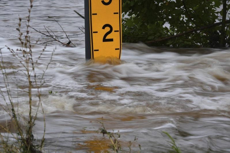 A flood gauge marks the height of water flowing over a farm-to-market road near Kerrville, Texas, on Friday, July 4, 2025