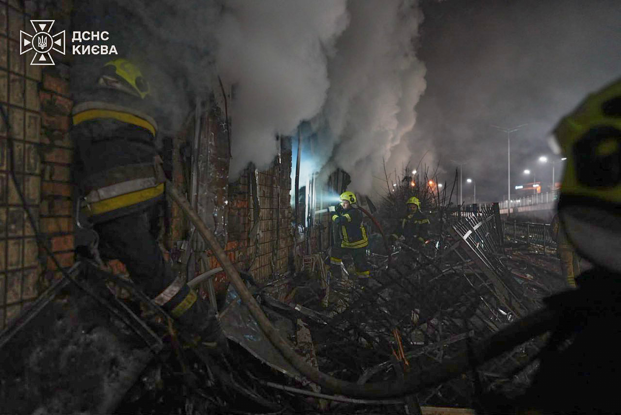 In this photo provided by the Ukrainian Emergency Service, emergency services personnel work to extinguish a fire following Russian missile attacks in Kyiv, Ukraine, Tuesday, Oct. 27, 2026.