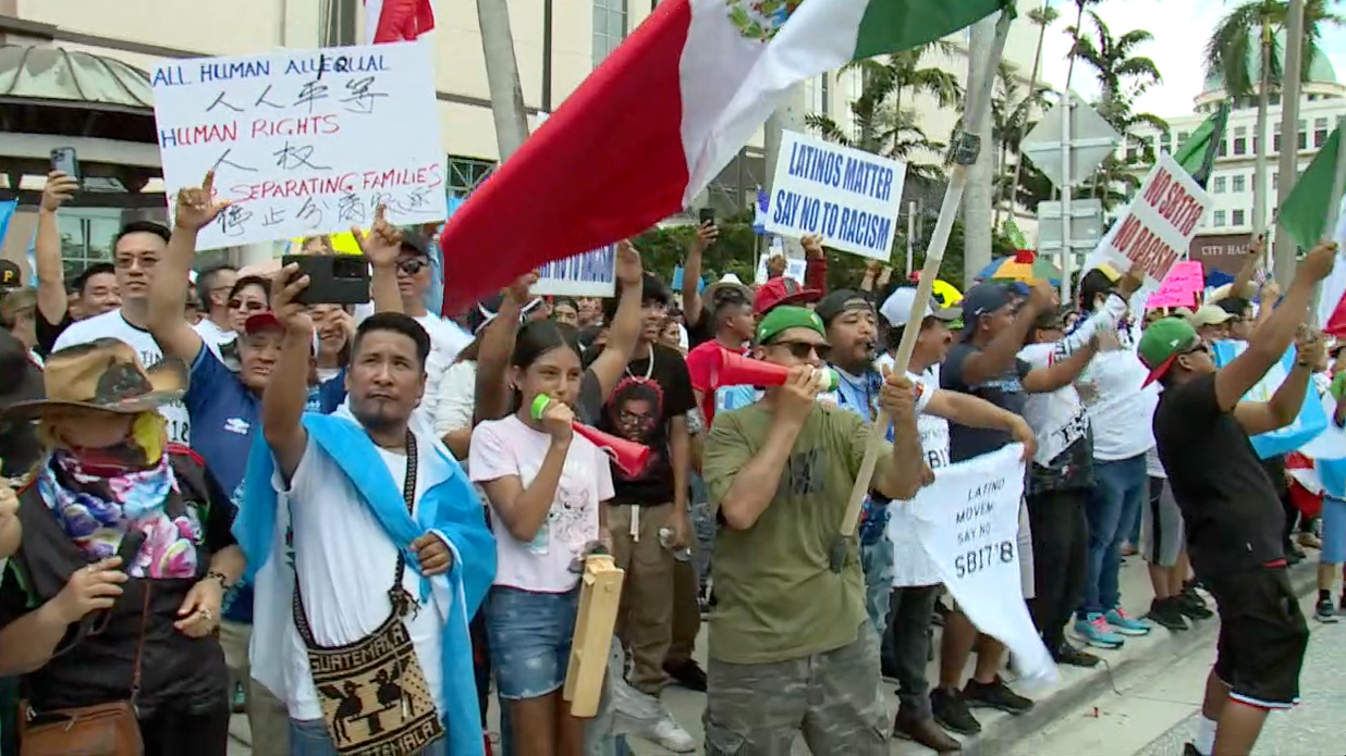 Protesters march through West Palm Beach on June 1, 2023, in opposition to Florida's new immigration laws. 