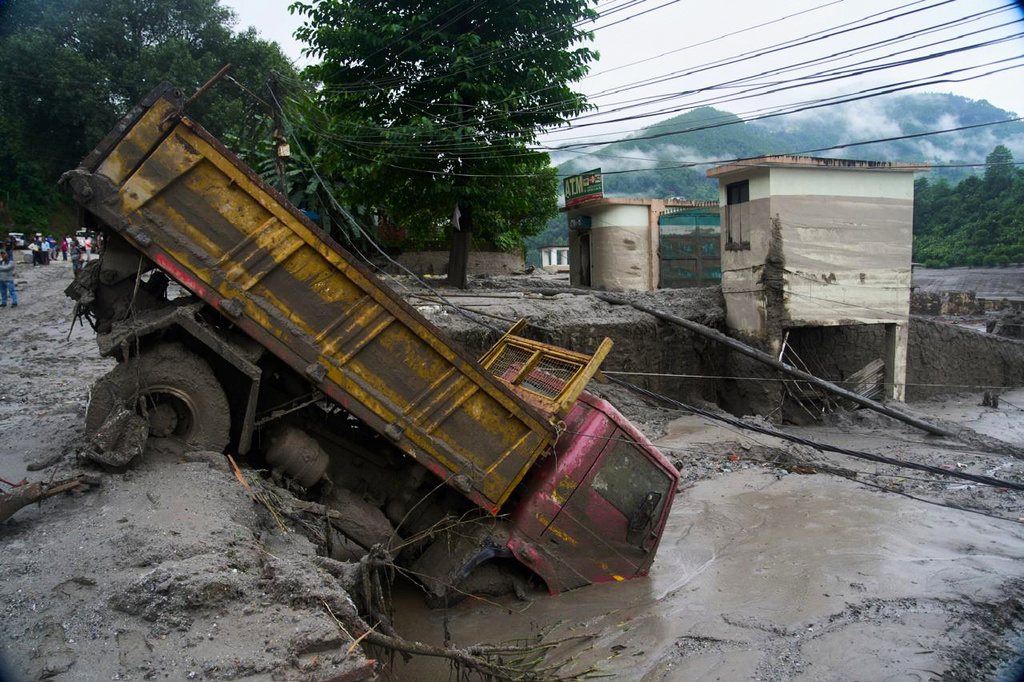 A vehicle is seen in the aftermath of a flash floods in Devighat in the Nuwakot district in Nepal. Thursday, Aug 27, 2026. 