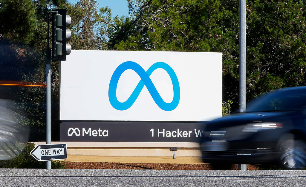 A car passes Facebook's new Meta logo on a sign at the company headquarters on Oct. 28, 2021, in Menlo Park, Calif. 