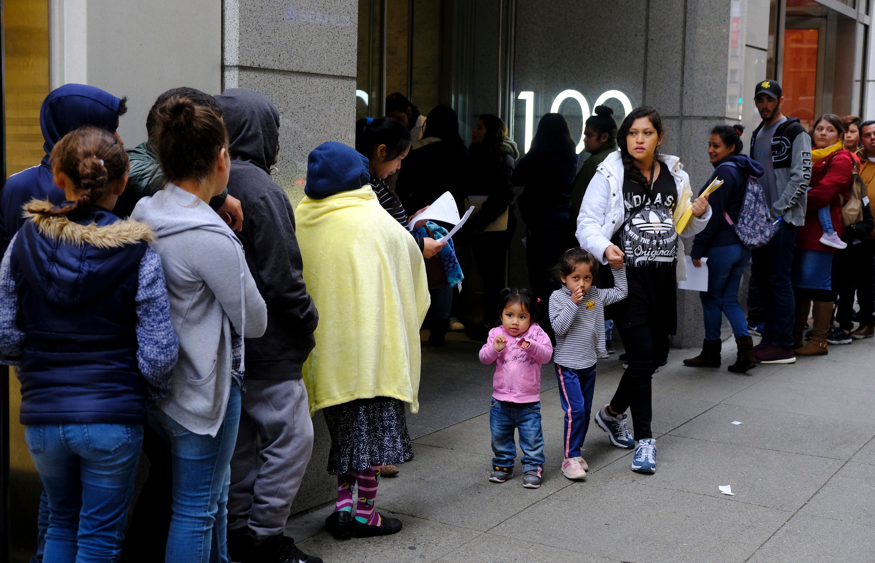 FILE - Hundreds of people stand in line outside a U.S. immigration office with numerous courtrooms in San Francisco, Jan. 31, 2019.