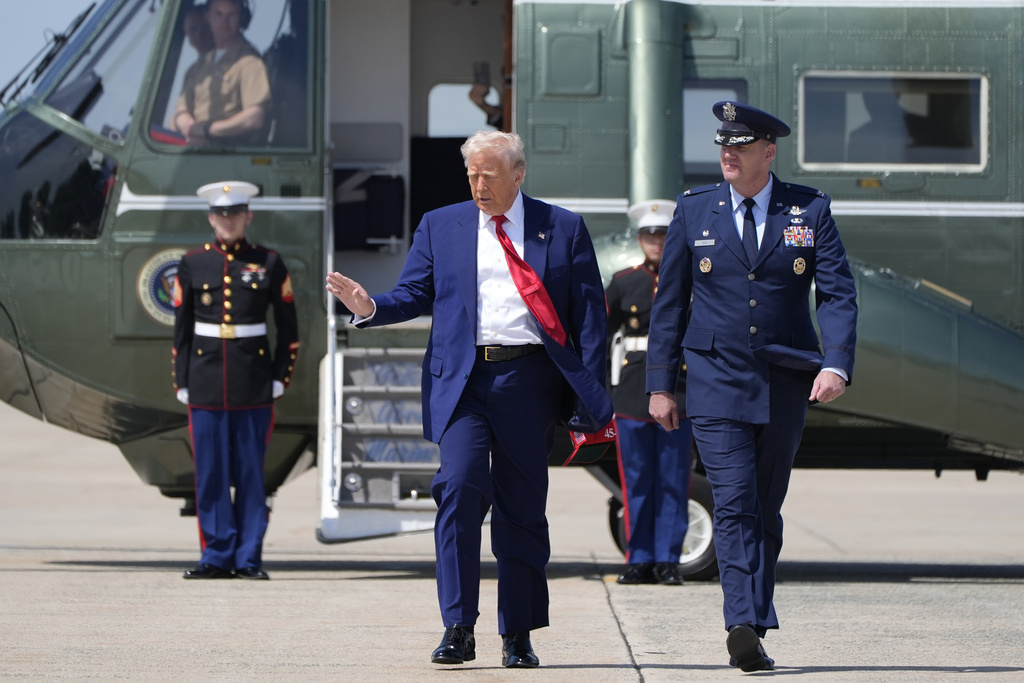 President Donald Trump walking across the tarmac before boarding Air Force One.