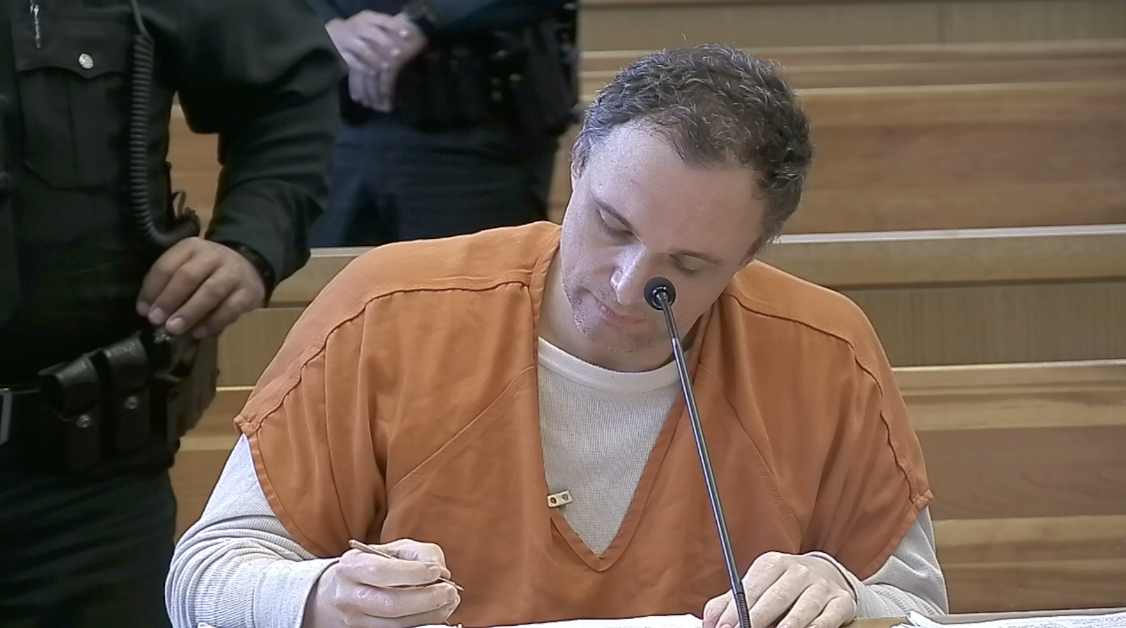 Tomas Kosowski sits in court, writing notes, during day three of his trial
