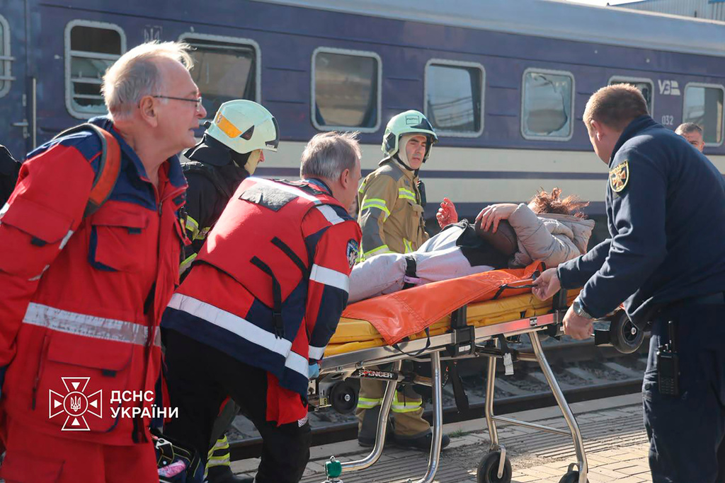 In this photo provided by the Ukrainian Emergency Service, rescuers evacuate a wounded civilian after a Russian drone attack on a railway platform in Dnipro, Ukraine, Thursday, Oct. 29, 2026. 
