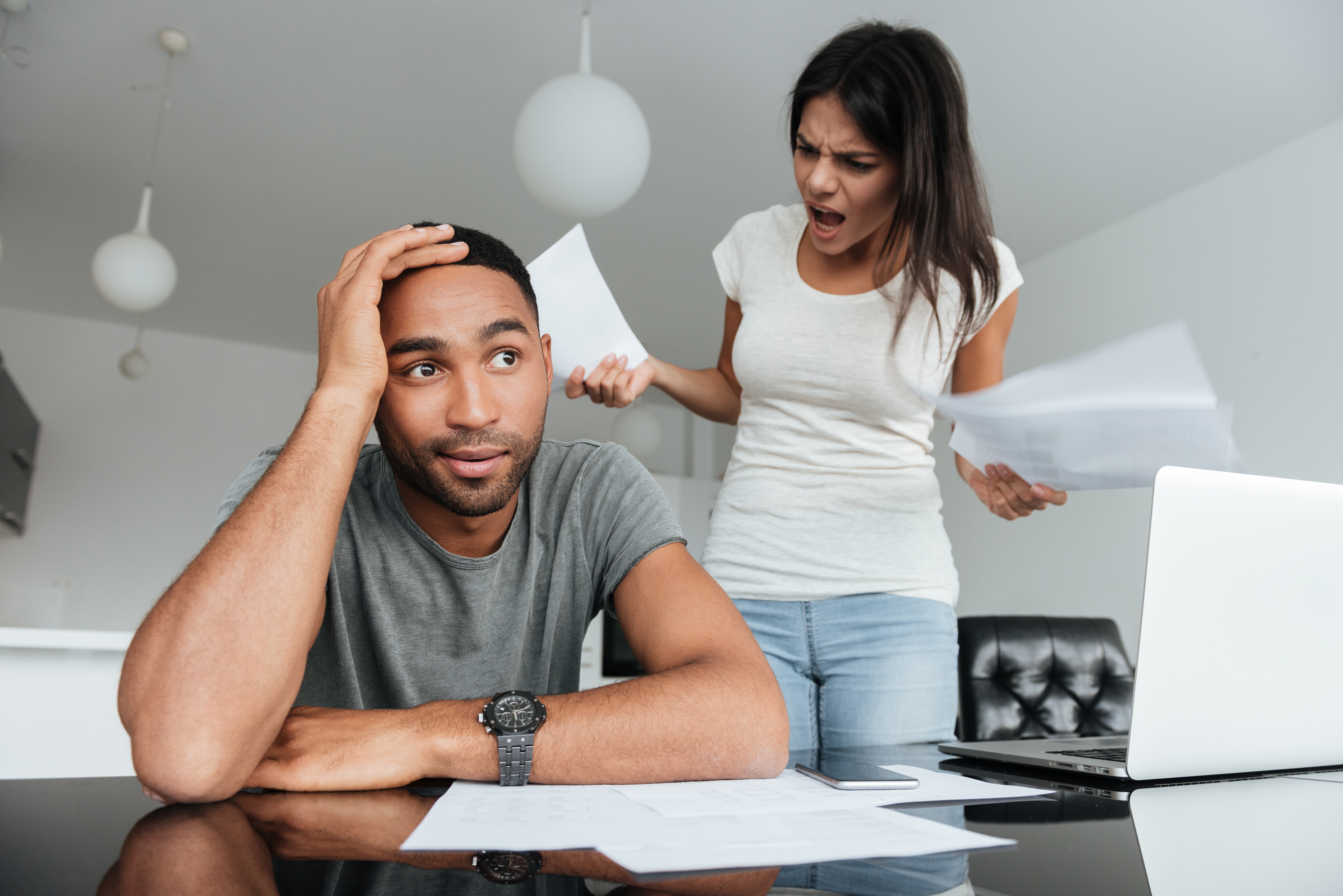 Loving couple discussing about domestic bills at home argue partner spouse fight