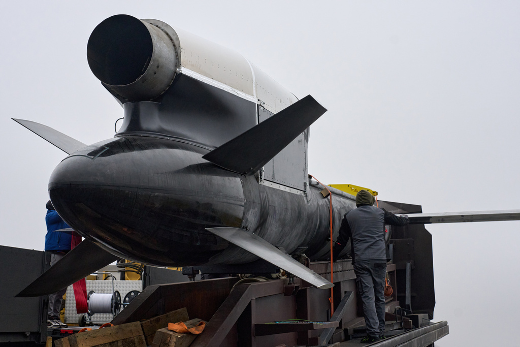 Workers and military inspect Ukrainian Fire Point's Flamingo missiles.