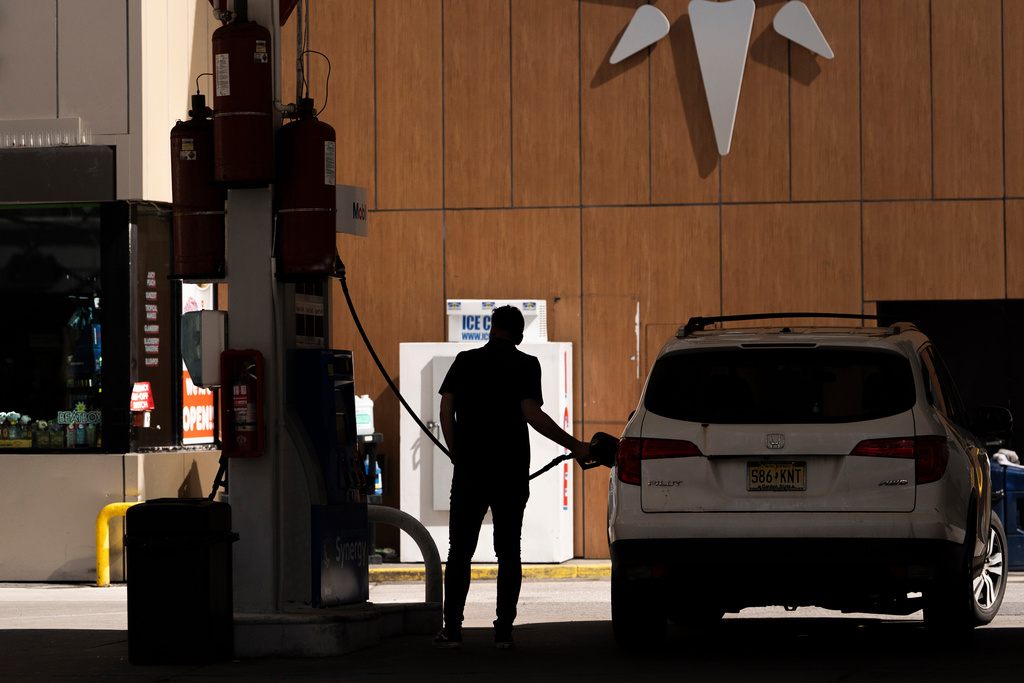 FILE - A person gets gas at a station March 10, 2026, in New York. 